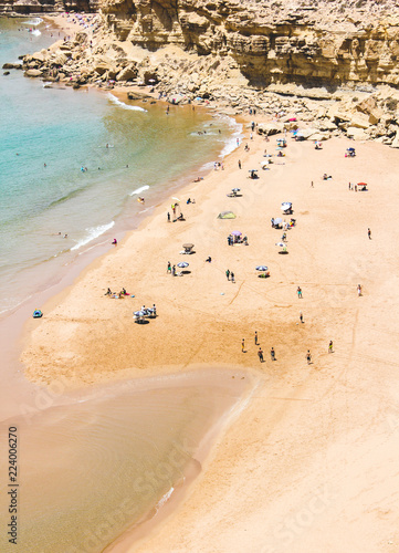 People Enjoying a Sunny Day on the Beach photo