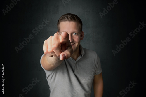 Smiling man pointing his finger to you