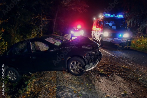 Real event. Car accident. The car crashed at night on a wet road . Car accident over raining day in autumn time. Rescuers help with car accident, ambulance, fire and police.