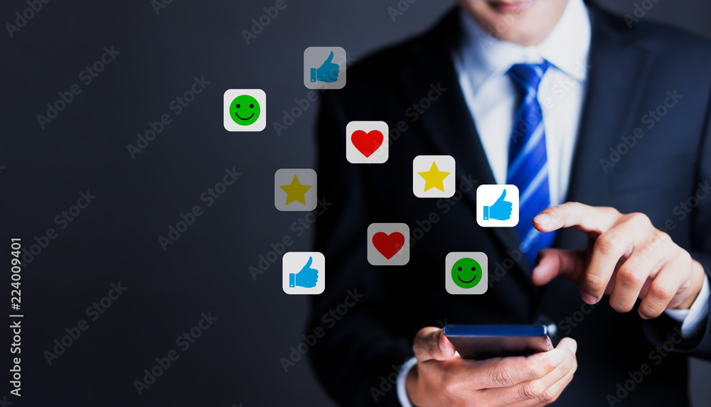 Businessman use smartphones to rate their satisfaction. Customer service experience and satisfaction survey concept Businessman use smartphones to rate their satisfaction. Customer service experience and satisfaction survey concept