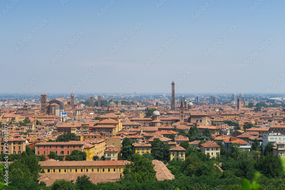 View of the orange medieval skyline of Bologna with brick buildings, seen from the arbours leading to the sanatorium
