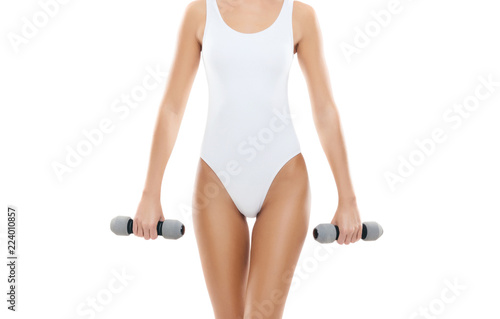 Fit and beautiful woman in swimsuit. Sporty girl with dumbbells. Fitness, diet and healthy lifestyle concept.