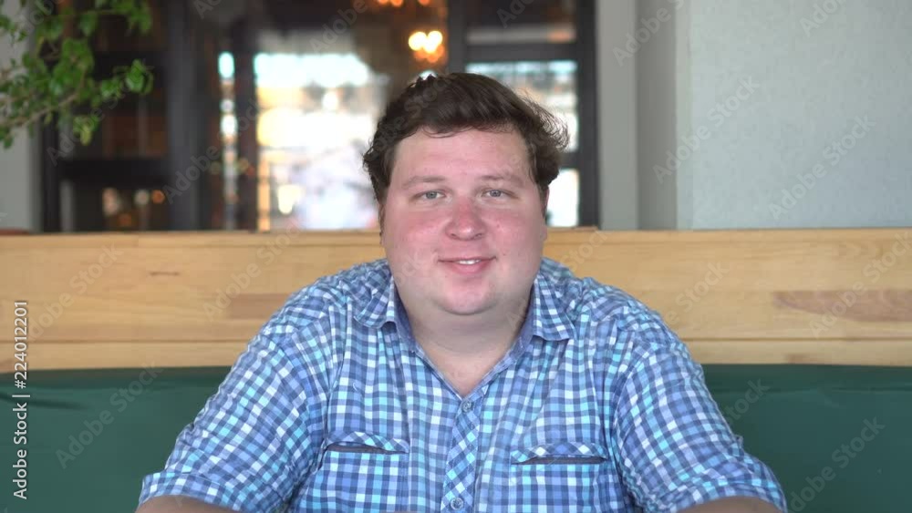 Fat man is looking at camera Fat man is looking at camera