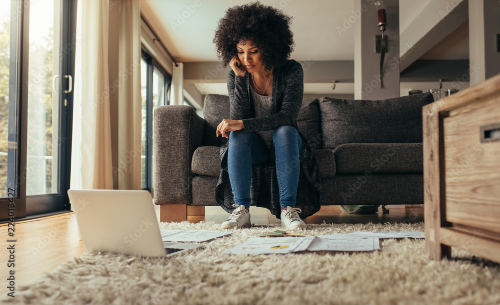 Woman at home studying business papers Woman at home studying business papers