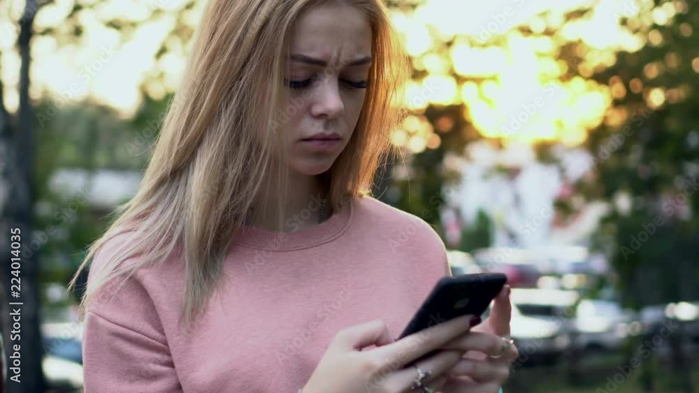 girl reads message with bad news on smartphone girl reads message with bad news on smartphone