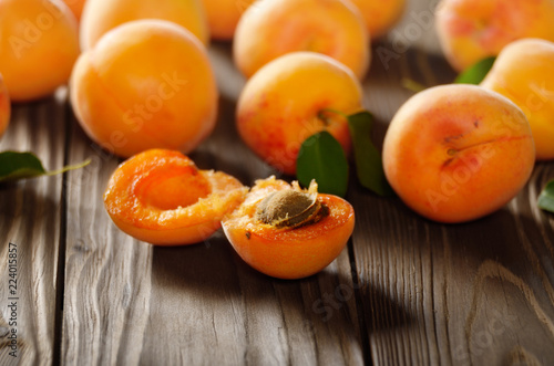 Ripe organic apricots on wooden table closeup
