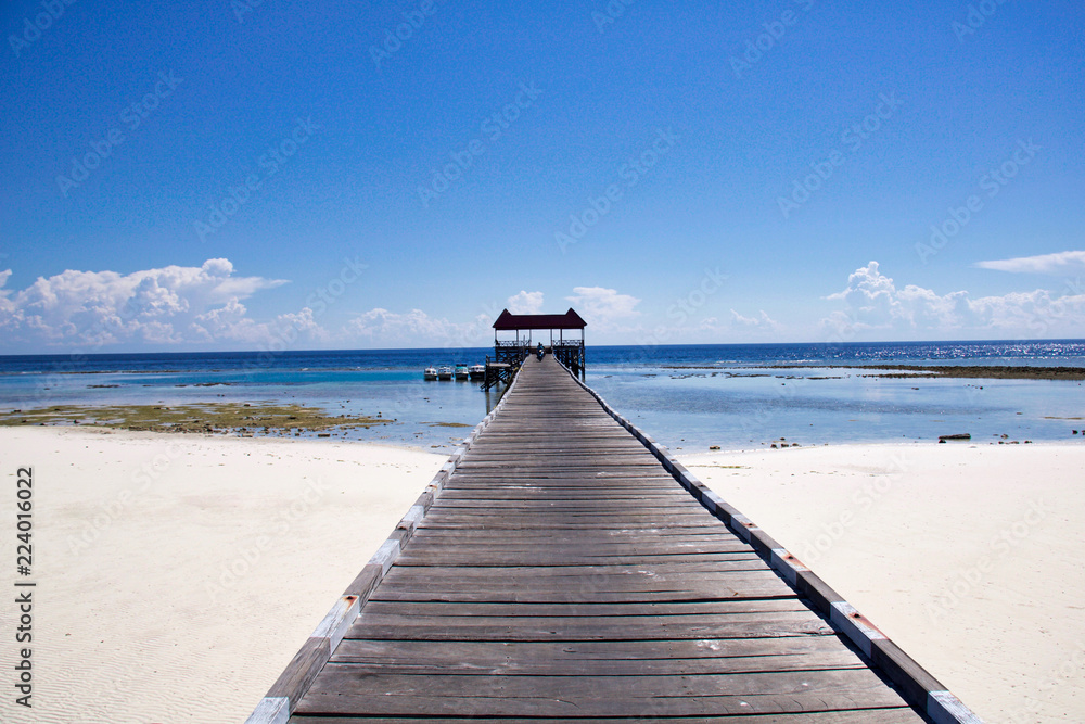 white sand and wooden pier in exotic seascape