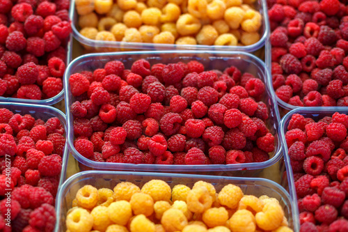 red and yellow raspberries in boxes, healthy food concept