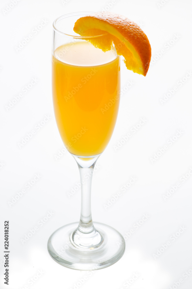 Glass of mimosa cocktail ready to be served for brunch with an orange slice