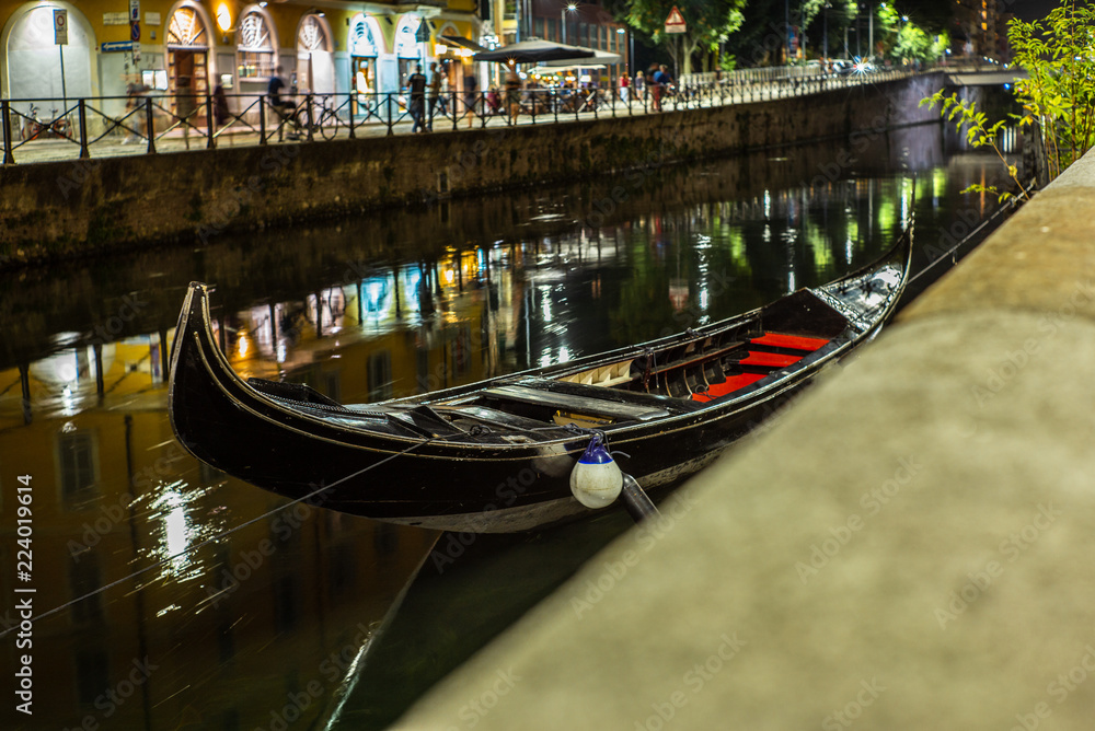 Uncommon sight of a Venetian gondola moored on the Naviglio Grande in Milan