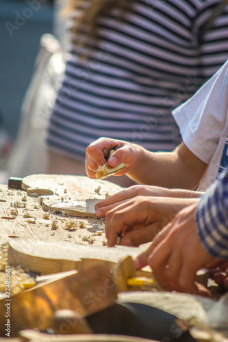 Children learn to make custom violin and other musical instruments in outdoor fablab classes. Joiner's training on makerfaire.