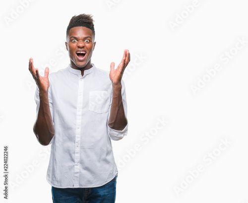 Young african american man over isolated background crazy and mad shouting and yelling with aggressive expression and arms raised. Frustration concept.