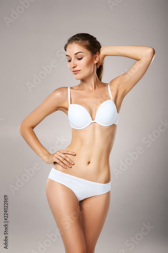 Slim tanned woman in underwear