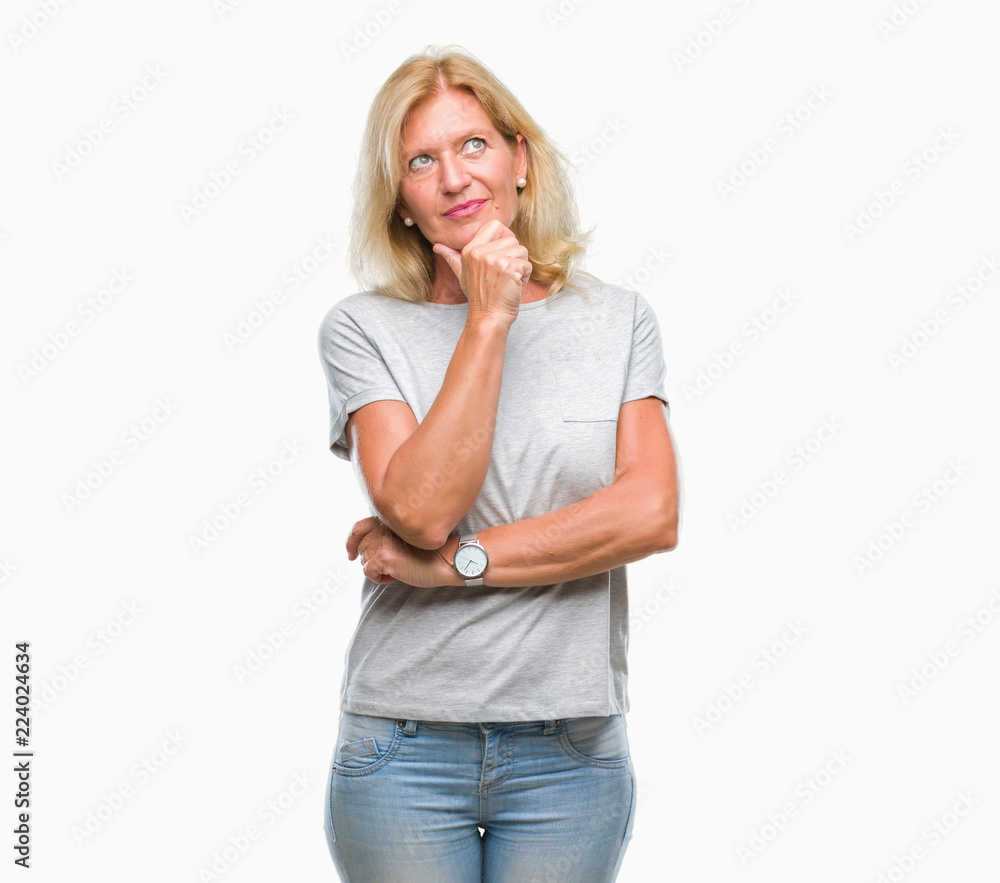 Middle age blonde woman over isolated background looking confident at the camera with smile with crossed arms and hand raised on chin. Thinking positive. Middle age blonde woman over isolated background looking confident at the camera with smile with crossed arms and hand raised on chin. Thinking positive.
