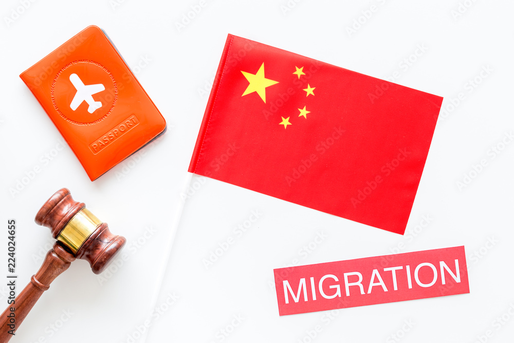 Immigration to China concept. Text innigration near passport cover and chinese flag, judge hammer on white background top view copy space Immigration to China concept. Text innigration near passport cover and chinese flag, judge hammer on white background top view copy space
