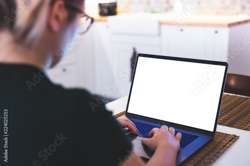 Girl using laptop with blank screen