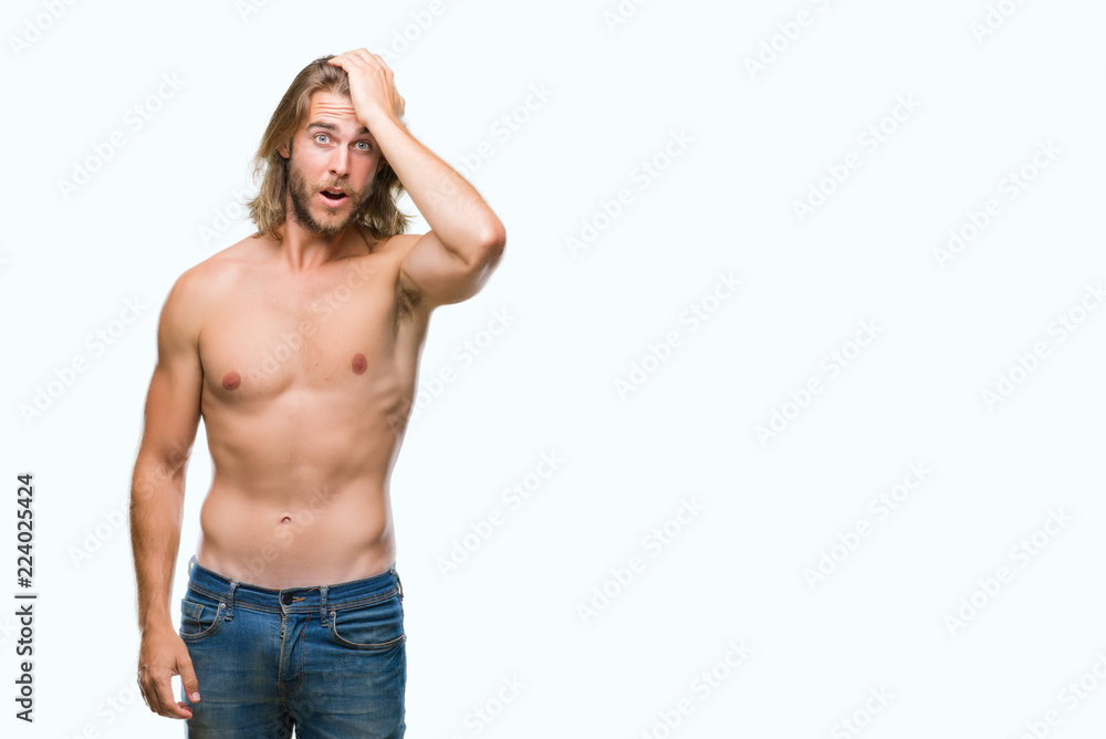Young handsome shirtless man with long hair showing sexy body over isolated background surprised with hand on head for mistake, remember error. Forgot, bad memory concept.