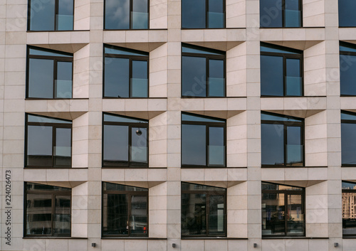 Abstract facade of new modern building wall with windows, house exterior