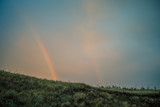 Double rainbow in the field, view from the mountain