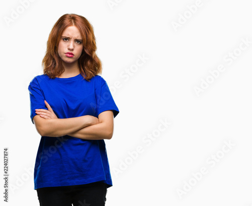 Young beautiful woman over isolated background skeptic and nervous, disapproving expression on face with crossed arms. Negative person.