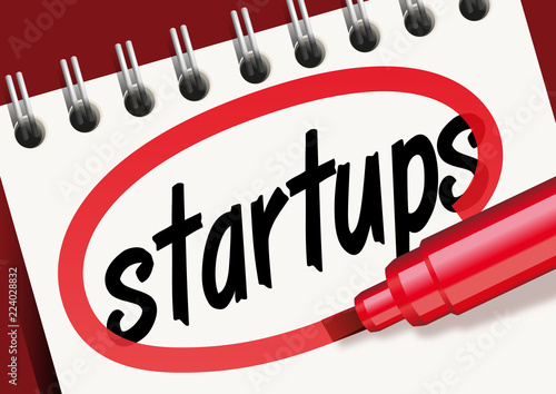 Le mot startups écrit et entouré de rouge sur un bloc-notes pour une présentation