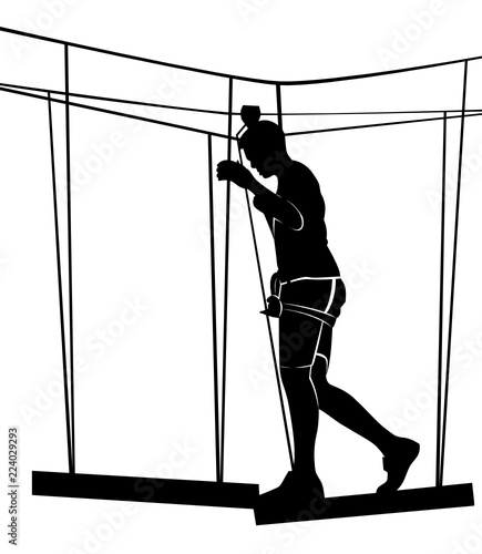 boy in adventure park rope ladder. Silhouette Adventure
