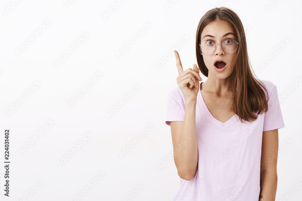 I got excellent suggestion. Smart and creative excited good-looking girl in glasses opening mouth while telling eureka raising index finger thinking up perfect plan against white background I got excellent suggestion. Smart and creative excited good-looking girl in glasses opening mouth while telling eureka raising index finger thinking up perfect plan against white background