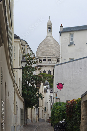 Houses and rue de Montmartre in Paris with the basilica in the background