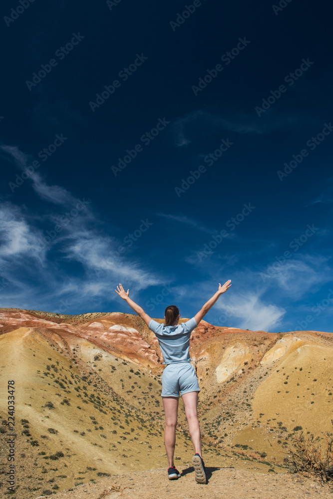 Woman in valley of Mars landscapes in the Altai Mountains, Kyzyl Chin, Siberia, Russia Woman in valley of Mars landscapes in the Altai Mountains, Kyzyl Chin, Siberia, Russia