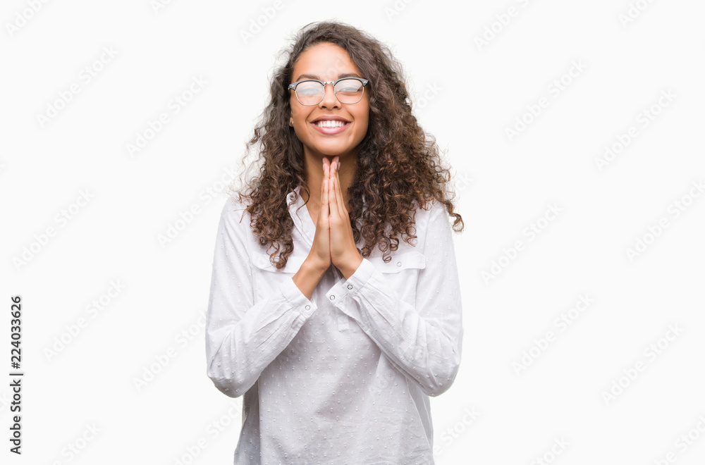 Beautiful young hispanic woman praying with hands together asking for forgiveness smiling confident. Beautiful young hispanic woman praying with hands together asking for forgiveness smiling confident.