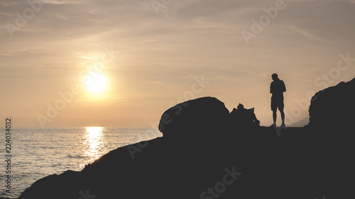 man on the rocks at sunset