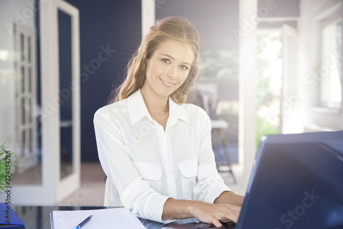 Businesswoman typing on laptop in the office