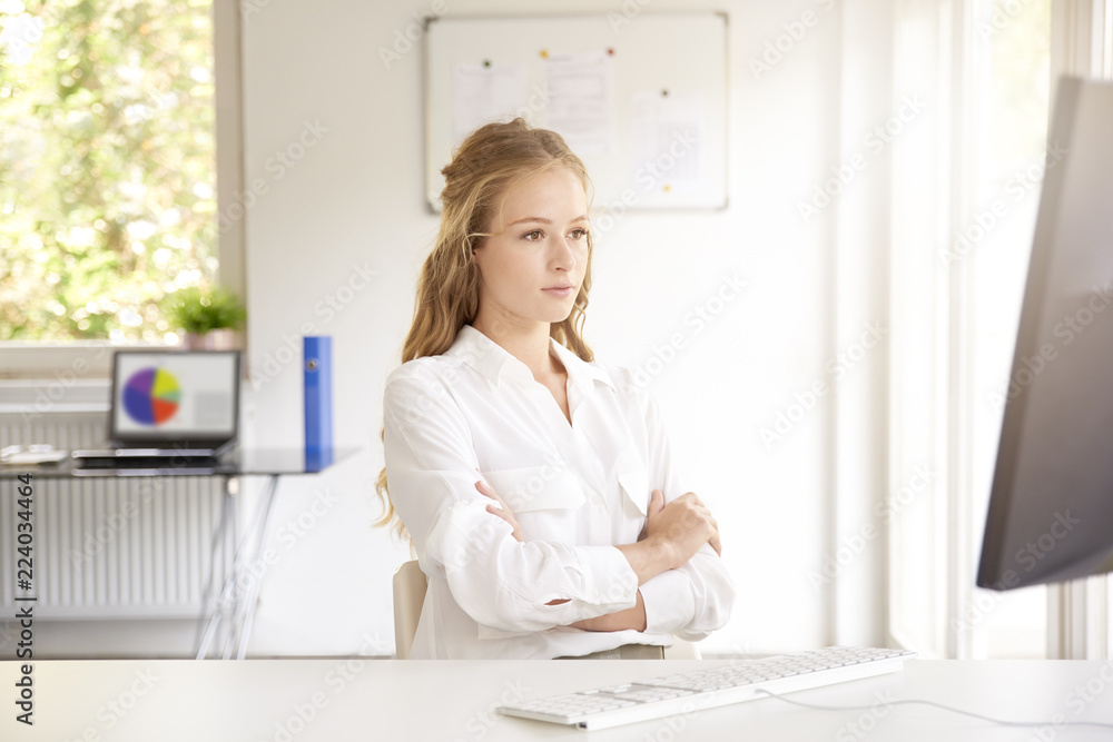 Thinking young businesswoman in the office Thinking young businesswoman in the office