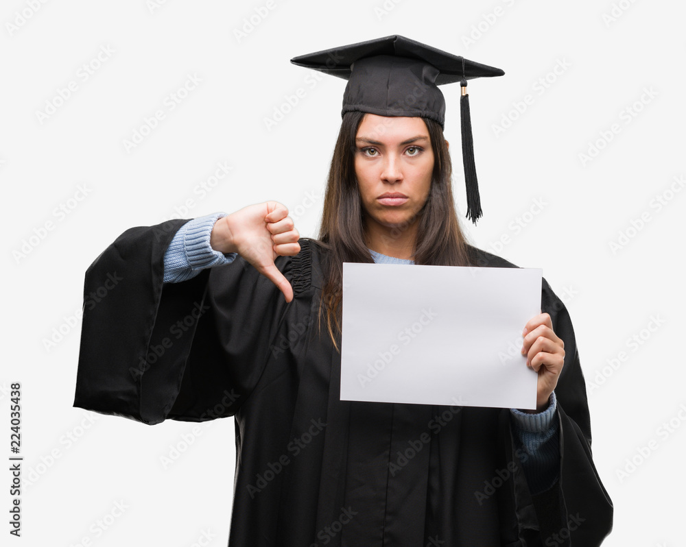 Young hispanic woman wearing graduated uniform holding diploma paper with angry face, negative sign showing dislike with thumbs down, rejection concept Young hispanic woman wearing graduated uniform holding diploma paper with angry face, negative sign showing dislike with thumbs down, rejection concept