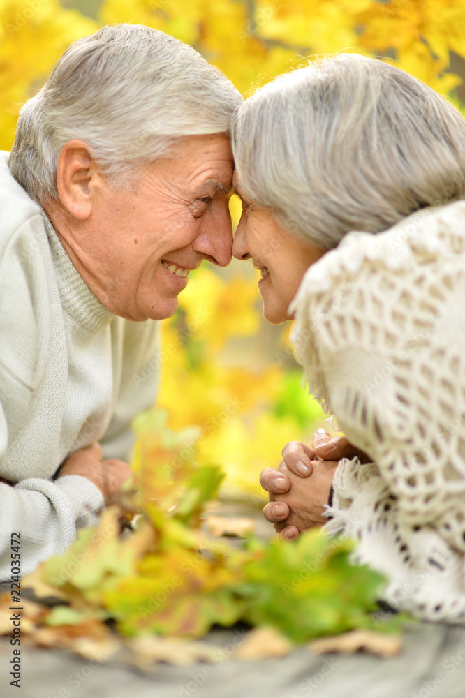 Elderly couple at table in autumn forest Elderly couple at table in autumn forest
