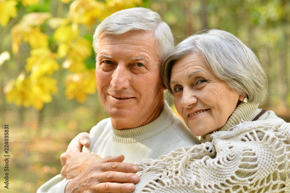 Happy senior couple in autumn park hugging Happy senior couple in autumn park hugging