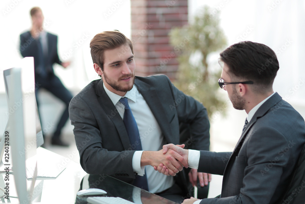 Image of two young businessmen interacting at meeting in office Image of two young businessmen interacting at meeting in office