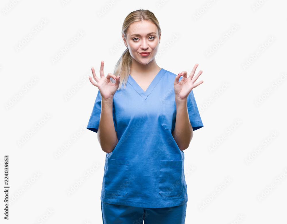 Young blonde surgeon doctor woman wearing medical uniform over isolated background relax and smiling with eyes closed doing meditation gesture with fingers. Yoga concept. Young blonde surgeon doctor woman wearing medical uniform over isolated background relax and smiling with eyes closed doing meditation gesture with fingers. Yoga concept.