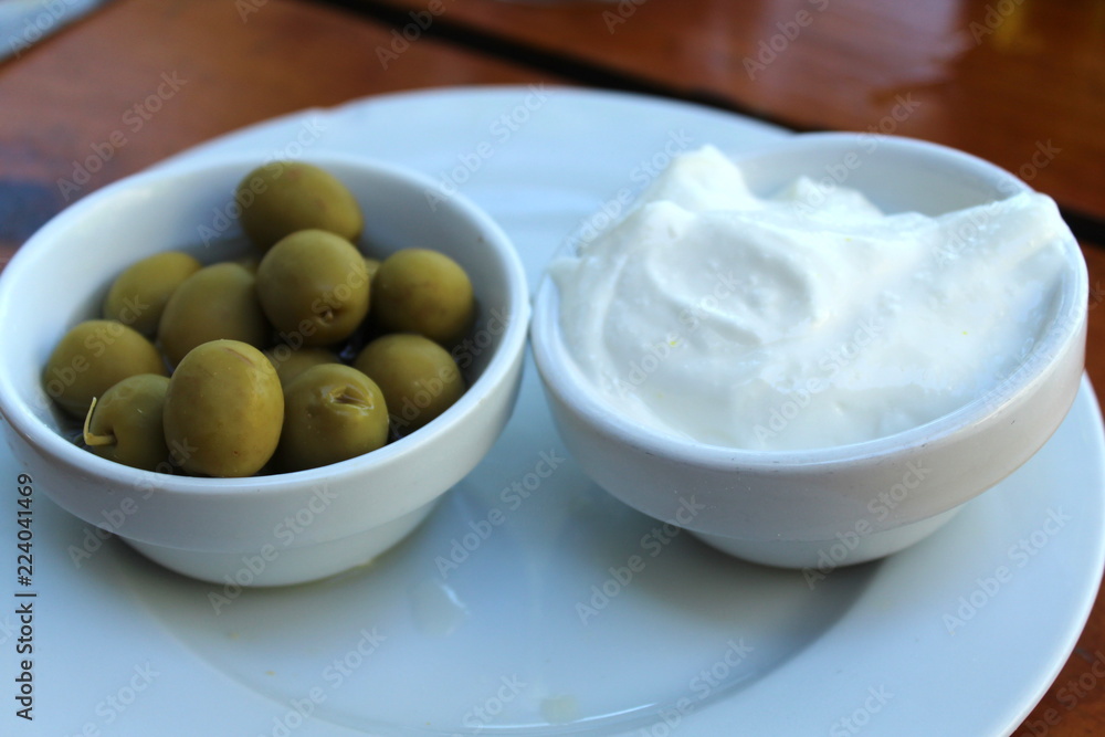 typical Ibiza and spanish starter: ali y oli (garlic cream) with bread and olives typical Ibiza and spanish starter: ali y oli (garlic cream) with bread and olives
