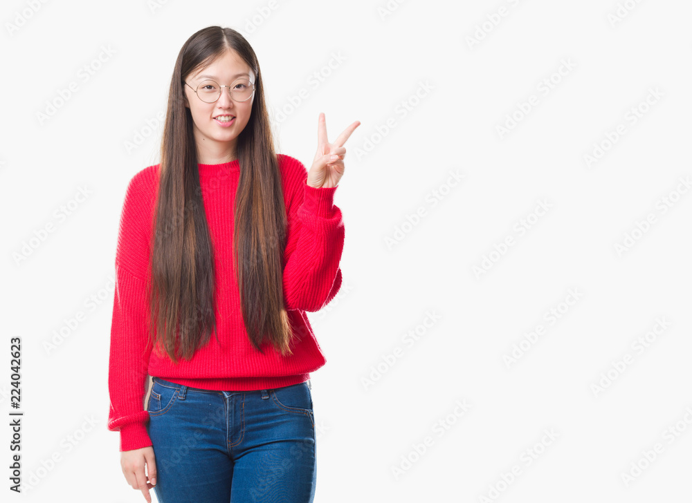 Young Chinese woman over isolated background wearing glasses showing and pointing up with fingers number two while smiling confident and happy. Young Chinese woman over isolated background wearing glasses showing and pointing up with fingers number two while smiling confident and happy.