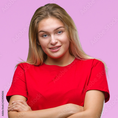 Young caucasian woman over isolated background happy face smiling with crossed arms looking at the camera. Positive person.