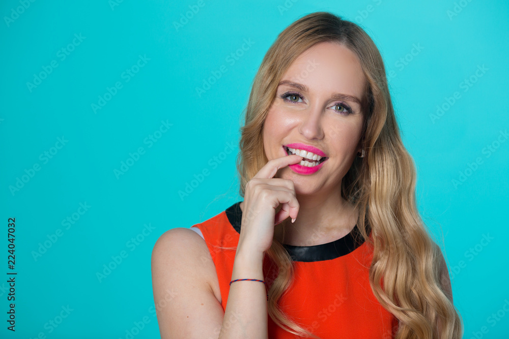 beautiful young girl with her hair on a blue background beautiful young girl with her hair on a blue background