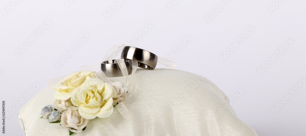 wedding rings - silver wedding rings on a white silk pillow wedding rings - silver wedding rings on a white silk pillow