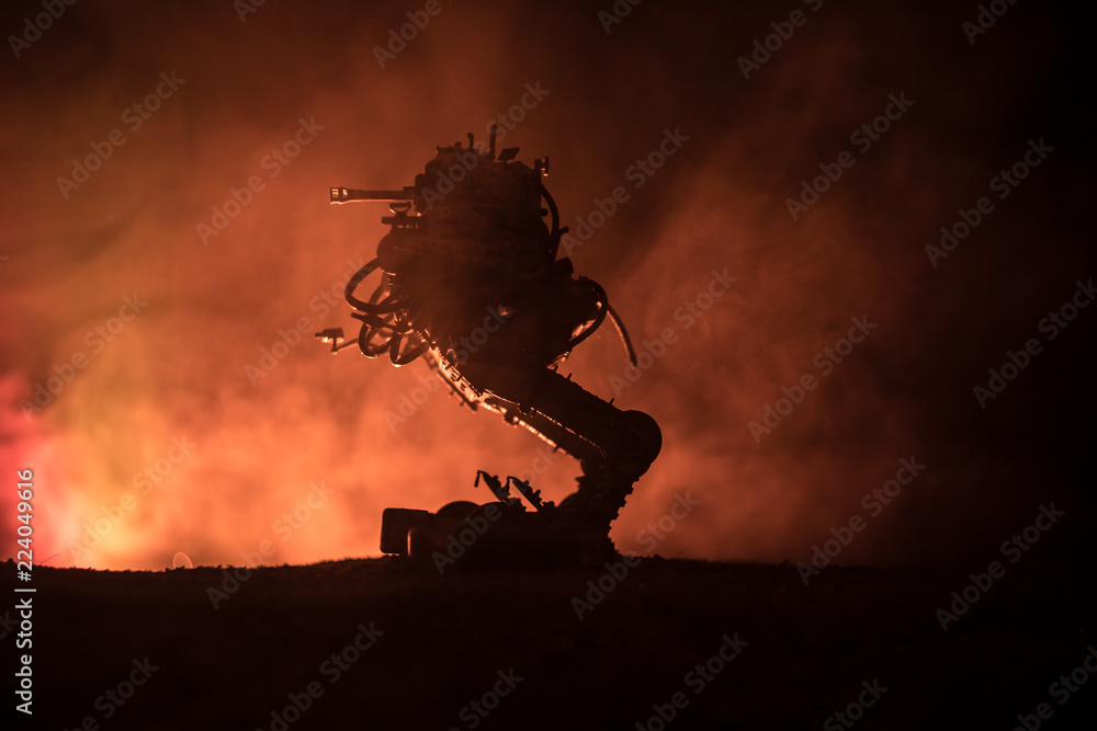 Silhouette of Giant robot. Futuristic tank in action with foggy fire sky background
