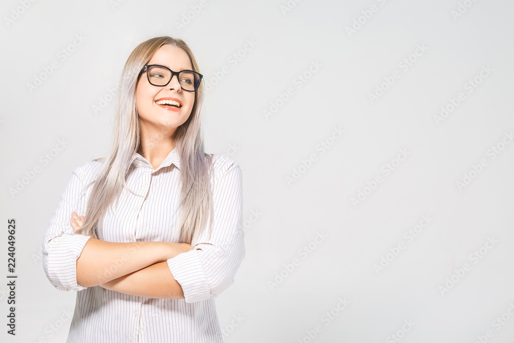 Happy cheerful young woman wearing her blonde hair at positive news or birthday gift, looking at camera with joyful and charming smile. Ginger student girl relaxing indoors after college