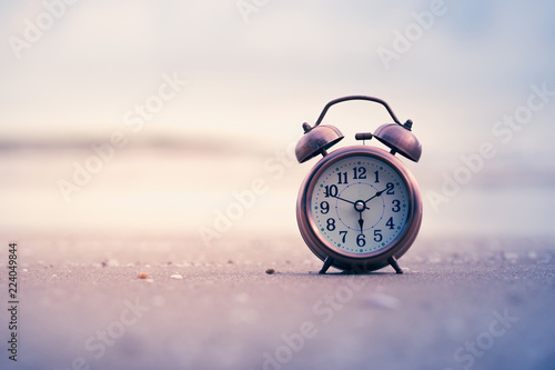 alarm clock ringing On the beach Blurred Background