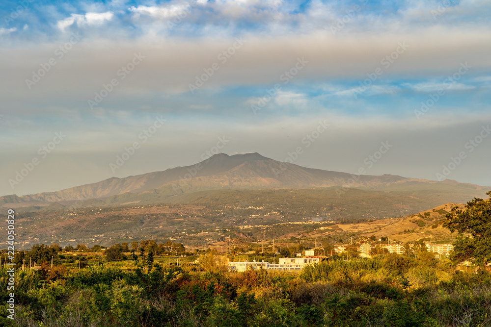 Fototapeta premium Etna volcano with clouds surrounding the mountain top