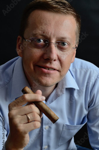 Man in blue shirt with cigar