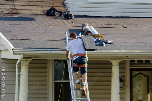 roofers are changing roof shingles