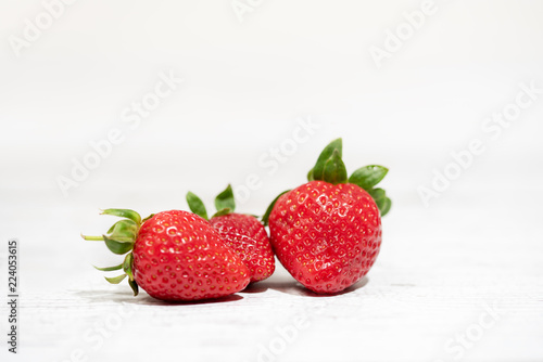 Strawberry on a white wood background. selective focus on strawberries